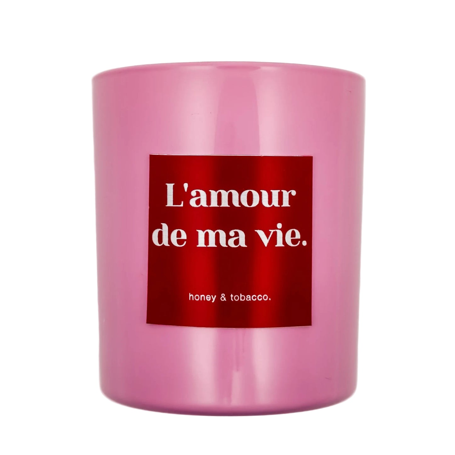 Pink candle with a red label displaying 'L'amour de ma vie' on a white background