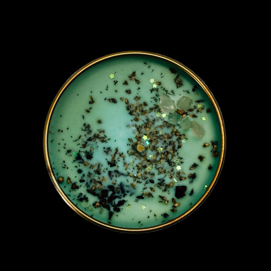 Green bowl with gold rim and decorative elements on a black background